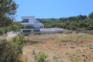 a house sitting on top of a hill at Apartments and rooms by the sea Arbanija, Ciovo - 1125 in Trogir