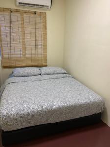 a bed in a room with a window and a bed sidx sidx sidx at JAVA 6 HOME 5 min to Jonker in Melaka