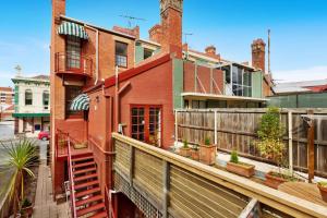 a house with a balcony with a fence at Fabulous 2 level city pad in historic building in Hobart