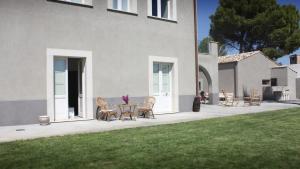 a patio with chairs and a table in front of a house at Terre di Senia in Chiaramonte Gulfi +45 photos