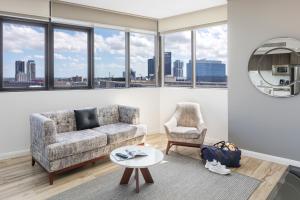 a living room with a couch and a table at Meriton Suites Church Street, Parramatta in Sydney