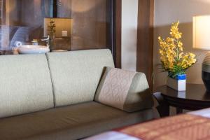 a couch in a living room with a table at Panviman Resort Koh Phangan - SHA Extra Plus in Thong Nai Pan Noi