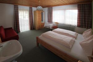 a bedroom with a bed and a sink and a bathroom at Haus Ganschitter in Wagrain