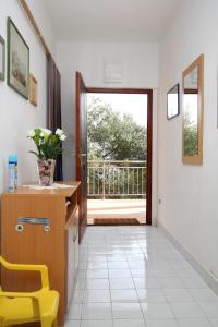 a hallway with a table and a yellow chair at Seaside secluded apartments Cove Skozanje, Hvar - 4024 in Gdinj