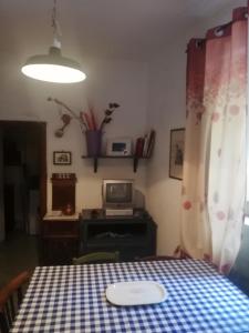 a table with a blue and white checkered table cloth at Casa caratteristica nel Parco del Cilento in Cuccaro Vetere