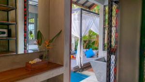 a room with a glass door leading to a bedroom at Vinna Villa Seminyak in Kerobokan +43 photos