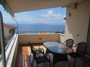 a table and chairs on a balcony with a view of the ocean at Seaside Boutique Villa in Volos +18 photos