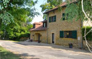 a stone house with a driveway in front of it at Gorgeous Apartment In Vitrac With Wifi in Vitrac