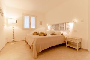 a bedroom with a bed with two towels on it at House On The Sea Porto Rotondo in Porto Rotondo