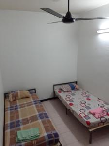 Postel nebo postele na pokoji v ubytování Homestay Idaman Penang