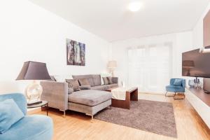 a living room with a couch and a tv at Fabelhafte Wohnungen in der Altstadt in Heidelberg +7 photos