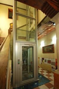 a glass door in a building with a tile floor at Hotel Torino in Venice