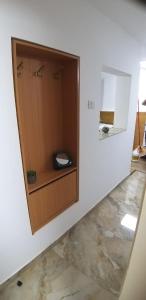 a bathroom with a wooden cabinet on a wall at Attic Ben Gurion 42 in Haifa