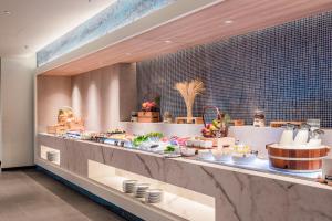 a buffet line with a lot of food on display at Oceanfront Beach Resort - SHA Extra Plus in Patong Beach