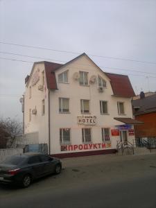 a car parked in front of a building at Hotel Kiev-S in Zhashkiv