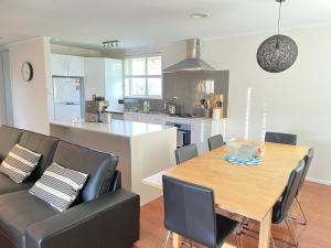 a kitchen and dining room with a table and chairs at Page 3BR House, Free WiFi, Netflix, Parking in Weetangerra