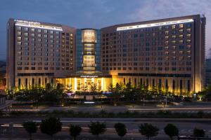 a rendering of a hotel building at night at Hotel Nikko Guangzhou - Complimentary shuttle service for concert event Baoneng&Olympic in Guangzhou