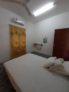 a bedroom with a white bed and a window at Homestay Idaman B B with 2 room aircond 2 Quen Bed and Not Sharing Room -Privacy in Kuala Terengganu