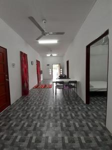 an empty room with a table and chairs in it at Homestay Idaman B B with 2 room aircond 2 Quen Bed and Not Sharing Room -Privacy in Kuala Terengganu