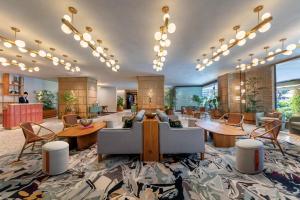 a lobby with a couch and tables and chairs at PARKROYAL on Beach Road, Singapore in Singapore