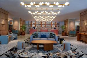 a lobby with a blue couch and a table at PARKROYAL on Beach Road, Singapore in Singapore