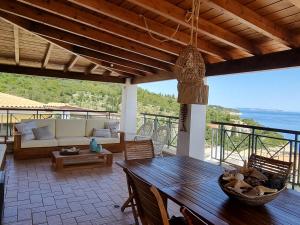 a living room with a table and a couch at Paxos villas in Gaios