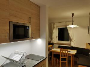 a kitchen and living room with a table and a dining room at Ferienwohnung Salzmann in Innsbruck