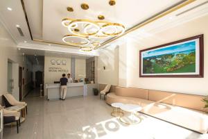 a man standing at a counter in a hospital lobby at Cat Ba Seoul 2 Hotel & Apartment in Cat Ba