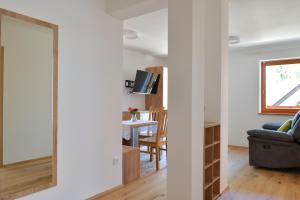 a living room with a mirror and a table at Farm Stay Jarc Vineyard in Svečina