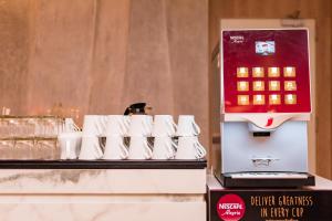 a coffee machine sitting on top of a table at Oceanfront Beach Resort - SHA Extra Plus in Patong Beach