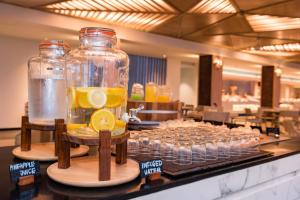 a buffet with glasses of lemonade in jars on a counter at Oceanfront Beach Resort - SHA Extra Plus in Patong Beach