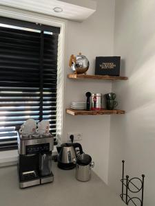 a kitchen with a toaster and a coffee maker on a counter at Holidayhome Geuzenhoeve op de Munnickaij in Schellinkhout