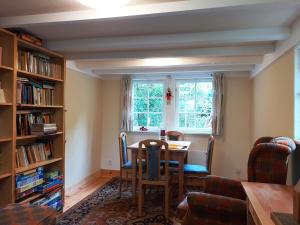 a dining room with a table and a window at Ferienwohnung Erika in Moritzburg