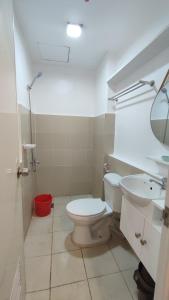 a bathroom with a toilet and a sink at CG's place (modern condo in cdo) in Cagayan de Oro