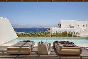 two beds sitting next to a swimming pool at PAROCKS Luxury Hotel & Spa in Ambelas