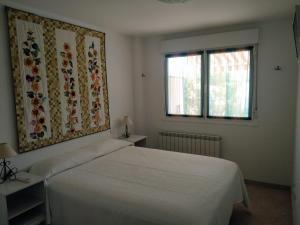 a bedroom with a white bed and a window at EL JARDIN DE LOS MANANTIALES in Castañares de Rioja +26 photos