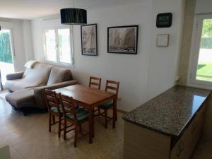 a living room with a table and a couch at EL JARDIN DE LOS MANANTIALES in Castañares de Rioja
