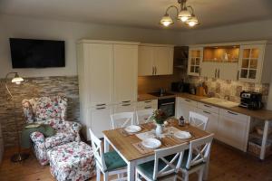 a kitchen with a table and a dining room at Slnečný dom in Liptovské Revúce