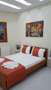 a bedroom with two beds and a painting on the wall at Heart of Kissamos Apartment in Kissamos