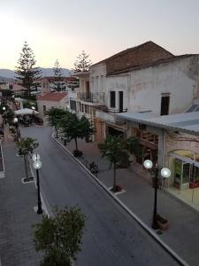 an empty street in a town with buildings and trees at Heart of Kissamos Apartment in Kissamos