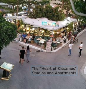 a group of people walking around an outdoor market at Heart of Kissamos Apartment in Kissamos