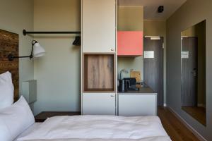 una camera con letto bianco e una cucina di FREIgeist Homes - Serviced Apartments a Gottinga