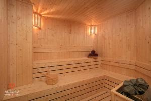 a wooden sauna with a bench and lights in it at Aurora Premium - A Lifestyle Hotel in Hanoi