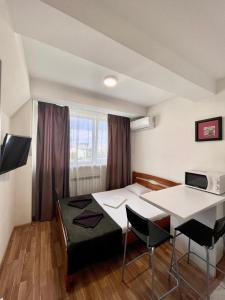 a room with a bed and a table and chairs at Apartmant in Kyiv for you in Kyiv