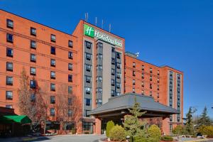 a building with a hotel sign on top of it at Holiday Inn Windsor - Ambassador Bridge, an IHG Hotel in Windsor