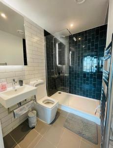 a bathroom with a toilet and a sink and a shower at The Perfect inn in London