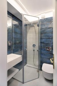 a bathroom with a glass shower and a toilet at Hotel Caraiman in Sinaia