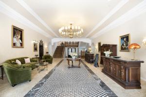 a living room filled with furniture and a chandelier at Hotel Caraiman in Sinaia