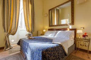 a bedroom with a bed with a mirror on the wall at Vatican Domus in Rome