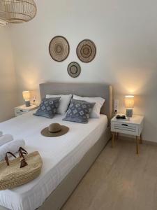 a bedroom with a white bed with a hat on it at Libera Private Rooms in Parga